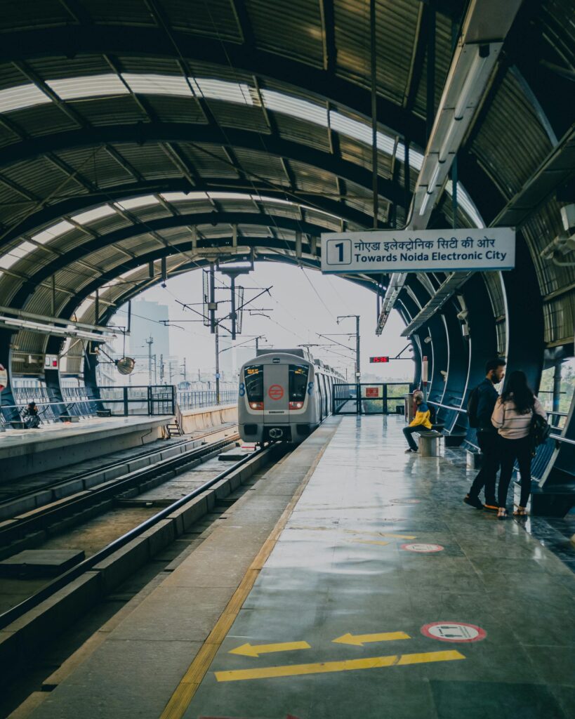 Urban metro station with a train arriving, showcasing public transportation hub.