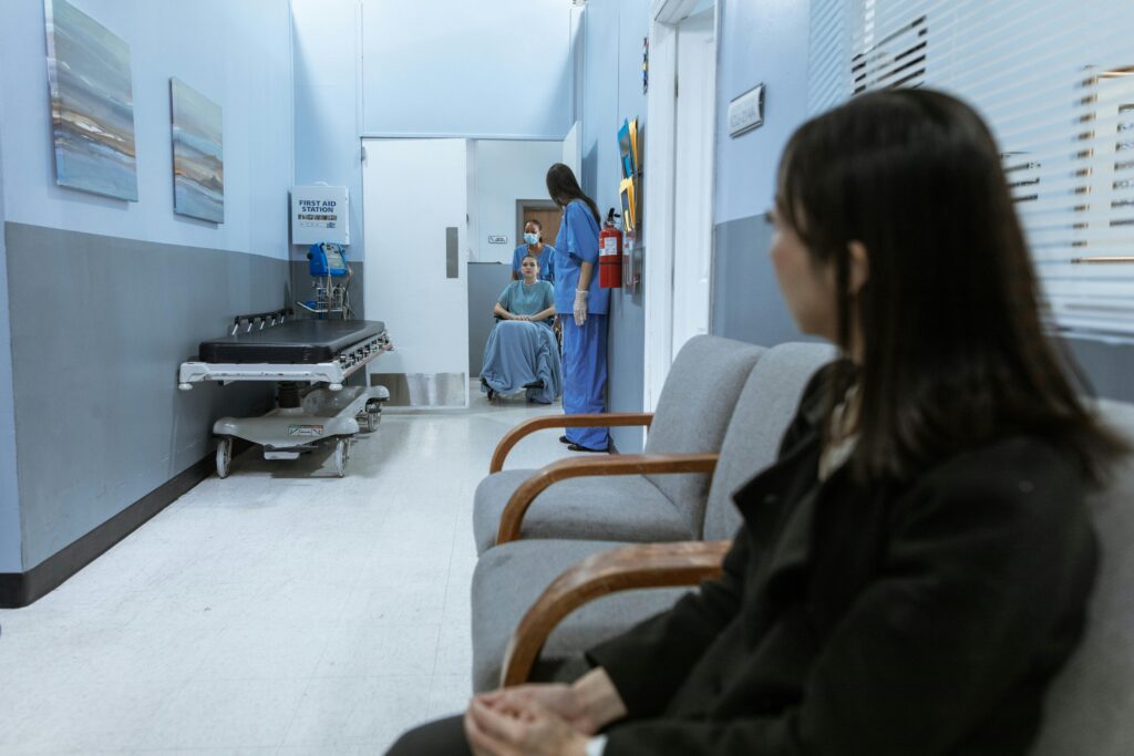 A hospital scene showing patients and medical staff in a corridor, illustrating healthcare environments.